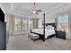 Main bedroom features a trey ceiling, four poster bed and ensuite bathroom at 7740 Nesbit Ferry Rd, Atlanta, GA 30350
