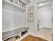 Well-organized mudroom with built-in bench, shoe storage, and access to the laundry room at 7740 Nesbit Ferry Rd, Atlanta, GA 30350