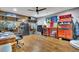 Office with a hardwood floor, overhead fan and lighting, with a work bench and overhead shelving at 7740 Nesbit Ferry Rd, Atlanta, GA 30350