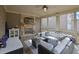 Covered patio with fireplace, television, comfortable seating, and screened windows at 7740 Nesbit Ferry Rd, Atlanta, GA 30350