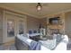 Covered patio with fireplace, television, comfortable seating, and screened windows at 7740 Nesbit Ferry Rd, Atlanta, GA 30350