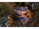 Aerial view of the home with a swimming pool and patio area at night at 1525 Lockridge Dr, Cumming, GA 30041