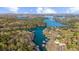 Expansive aerial view of a lake community, surrounded by lush trees and clear blue waters at 1525 Lockridge Dr, Cumming, GA 30041