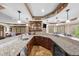 Basement bar featuring granite countertops, custom cabinetry, and ample seating at 1525 Lockridge Dr, Cumming, GA 30041