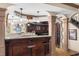 Basement bar with granite countertops, wooden cabinetry, and seating at 1525 Lockridge Dr, Cumming, GA 30041
