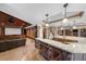 Finished basement with a granite countertop bar, theater area, and decorative columns at 1525 Lockridge Dr, Cumming, GA 30041