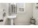 Small bathroom with a pedestal sink and patterned wallpaper at 1525 Lockridge Dr, Cumming, GA 30041