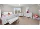 Cozy bedroom with a bed, crib, bench, and neutral tones at 1525 Lockridge Dr, Cumming, GA 30041
