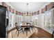 Charming dining room with natural light, plantation shutters, and modern lighting fixture at 1525 Lockridge Dr, Cumming, GA 30041