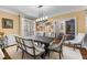 Dining room with natural light, plantation shutters, and modern light fixture at 1525 Lockridge Dr, Cumming, GA 30041