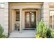 Arched front door with sidelights and decorative ironwork on a covered porch at 1525 Lockridge Dr, Cumming, GA 30041