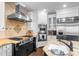 Gourmet kitchen featuring granite countertops, stainless steel appliances, and ample cabinet space at 1525 Lockridge Dr, Cumming, GA 30041