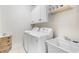 Laundry room with a white sink and a modern washer and dryer at 1525 Lockridge Dr, Cumming, GA 30041
