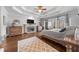 Spacious main bedroom with fireplace, tray ceiling, hardwood floors, and natural light at 1525 Lockridge Dr, Cumming, GA 30041