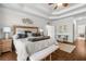 Spacious bedroom features a tray ceiling, hardwood floors, and an en suite bathroom at 1525 Lockridge Dr, Cumming, GA 30041