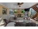 Covered patio featuring a stone fireplace, ceiling fan, and comfortable seating area at 1525 Lockridge Dr, Cumming, GA 30041
