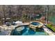 Pool and spa surrounded by nature with lounge chairs and a privacy fence at 1525 Lockridge Dr, Cumming, GA 30041