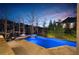 Enjoy a relaxing dip in this backyard pool with a hot tub, set against a backdrop of mature trees at 1525 Lockridge Dr, Cumming, GA 30041