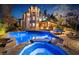 Backyard swimming pool and hot tub at night, lit with bright blue lights at 1525 Lockridge Dr, Cumming, GA 30041