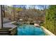 Beautiful backyard pool with a spa, stone accents, and lush greenery at 1525 Lockridge Dr, Cumming, GA 30041