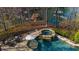 Backyard pool and spa overlook the water, creating a private and tranquil oasis at 1525 Lockridge Dr, Cumming, GA 30041