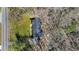 Aerial view of home with landscaped grounds surrounded by mature trees at 2415 Bankstone Sw Dr, Marietta, GA 30064
