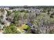An aerial view of a wooded lot with a charming brick home, surrounded by mature trees and a large lawn at 2415 Bankstone Sw Dr, Marietta, GA 30064