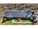 An aerial view showcases the house, and new roof with a well-maintained yard surrounded by mature trees at 2415 Bankstone Sw Dr, Marietta, GA 30064