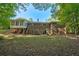 Spacious backyard featuring a brick house with a sunroom and a wooden deck perfect for entertaining at 2415 Bankstone Sw Dr, Marietta, GA 30064