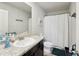 Well-lit bathroom with a granite countertop, single sink, framed mirror, toilet and a shower with a white curtain at 3464 Enterkin Ln, Atlanta, GA 30349