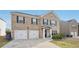 Attractive two-story brick home features a welcoming entrance and a two-car attached garage at 3464 Enterkin Ln, Atlanta, GA 30349
