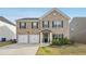 Charming two-story brick home with attached two-car garage and well-maintained front yard at 3464 Enterkin Ln, Atlanta, GA 30349