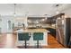 Open kitchen boasts stainless steel appliances, granite countertops, and a center island with barstool seating at 3464 Enterkin Ln, Atlanta, GA 30349