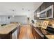 Modern kitchen featuring granite countertops, stainless steel appliances, and a view into the dining area at 3464 Enterkin Ln, Atlanta, GA 30349