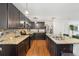 This kitchen has dark cabinets, stainless steel appliances, granite countertops, and a center island at 3464 Enterkin Ln, Atlanta, GA 30349