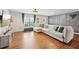 Living area featuring gray paneled wall, large sectional, and lots of natural light at 3464 Enterkin Ln, Atlanta, GA 30349