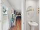 Bright powder room with a pedestal sink and adjacent kitchen access creates convenience for guests at 3464 Enterkin Ln, Atlanta, GA 30349