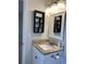 Cozy bathroom featuring granite countertop, white cabinets, decorative mirror, and dark shelving at 988 Old Holcomb Bridge Rd, Roswell, GA 30076