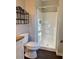 Bright bathroom with white shower, toilet, and dark wood-look flooring at 988 Old Holcomb Bridge Rd, Roswell, GA 30076