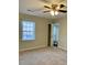 Bedroom with ceiling fan, window and an ensuite bathroom at 988 Old Holcomb Bridge Rd, Roswell, GA 30076