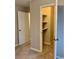 Secondary bedroom doorway view with walk-in closet and neutral colored carpet at 988 Old Holcomb Bridge Rd, Roswell, GA 30076