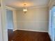 The dining room has a modern light fixture and wood floors at 988 Old Holcomb Bridge Rd, Roswell, GA 30076