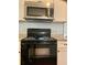 The kitchen features granite countertops and black appliances at 988 Old Holcomb Bridge Rd, Roswell, GA 30076