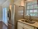 The kitchen features a stainless steel refrigerator, sink, and granite countertops at 988 Old Holcomb Bridge Rd, Roswell, GA 30076