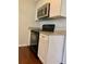 Kitchen featuring modern appliances, granite countertops, and white cabinetry at 988 Old Holcomb Bridge Rd, Roswell, GA 30076