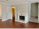 Cozy living room with hardwood floors, fireplace and view of the entryway staircase at 988 Old Holcomb Bridge Rd, Roswell, GA 30076