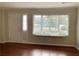 Bright living room featuring large windows and hardwood floors at 988 Old Holcomb Bridge Rd, Roswell, GA 30076