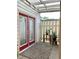 Exterior patio with red double doors, accent plants, and covered awning at 988 Old Holcomb Bridge Rd, Roswell, GA 30076