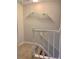 Carpeted staircase with white railing leads to the second level with decorative wall shelf at 988 Old Holcomb Bridge Rd, Roswell, GA 30076