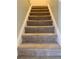 Carpeted stairs lead to the upper level of the home at 988 Old Holcomb Bridge Rd, Roswell, GA 30076